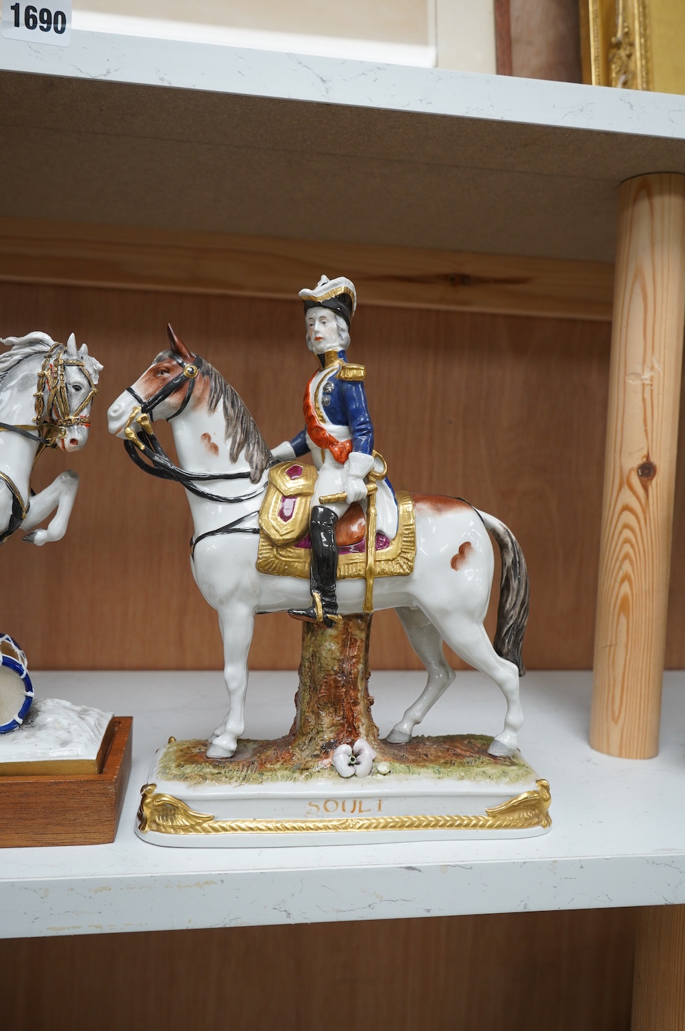 A group of three continental porcelain models of riders on horseback, tallest 27cm